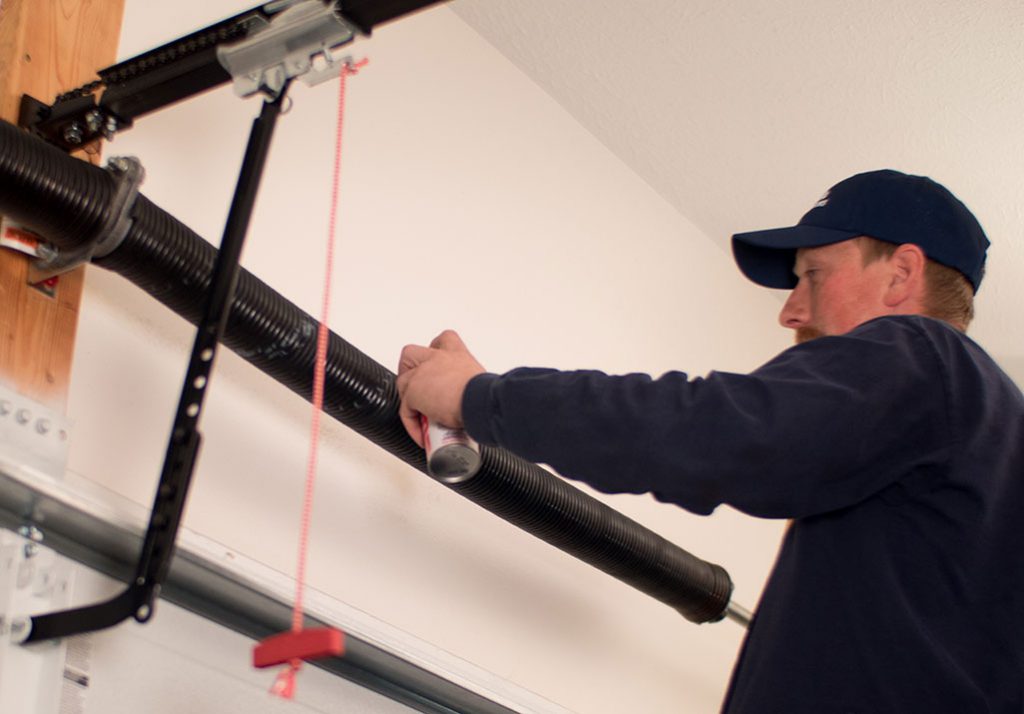 Maxim Garage Door technician performing Garage Door Spring Repair in Dallas