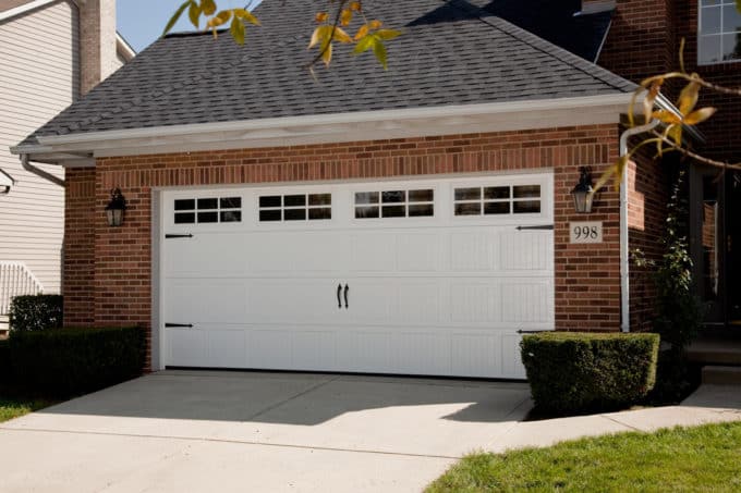 Maxim Garage Door technician installing Carriage Garage Doors in Dallas