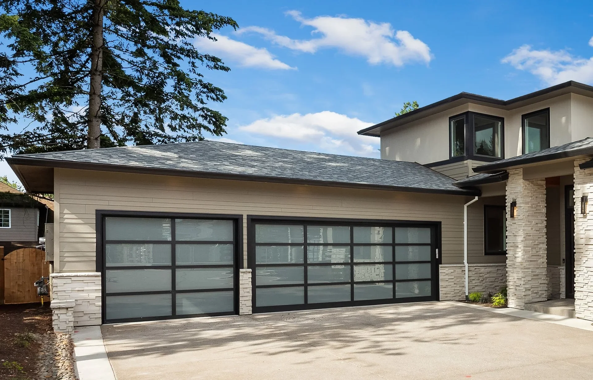 Maxim Garage Door technician installing Glass Garage Doors in Dallas