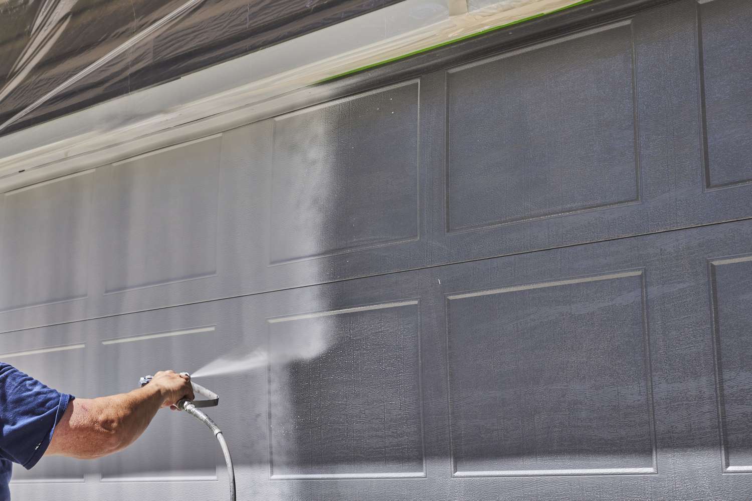 Maxim Garage Door technician installing Garage Door Painting Services in Dallas